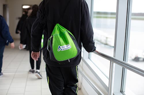 An Autism Aviator walking through the airport